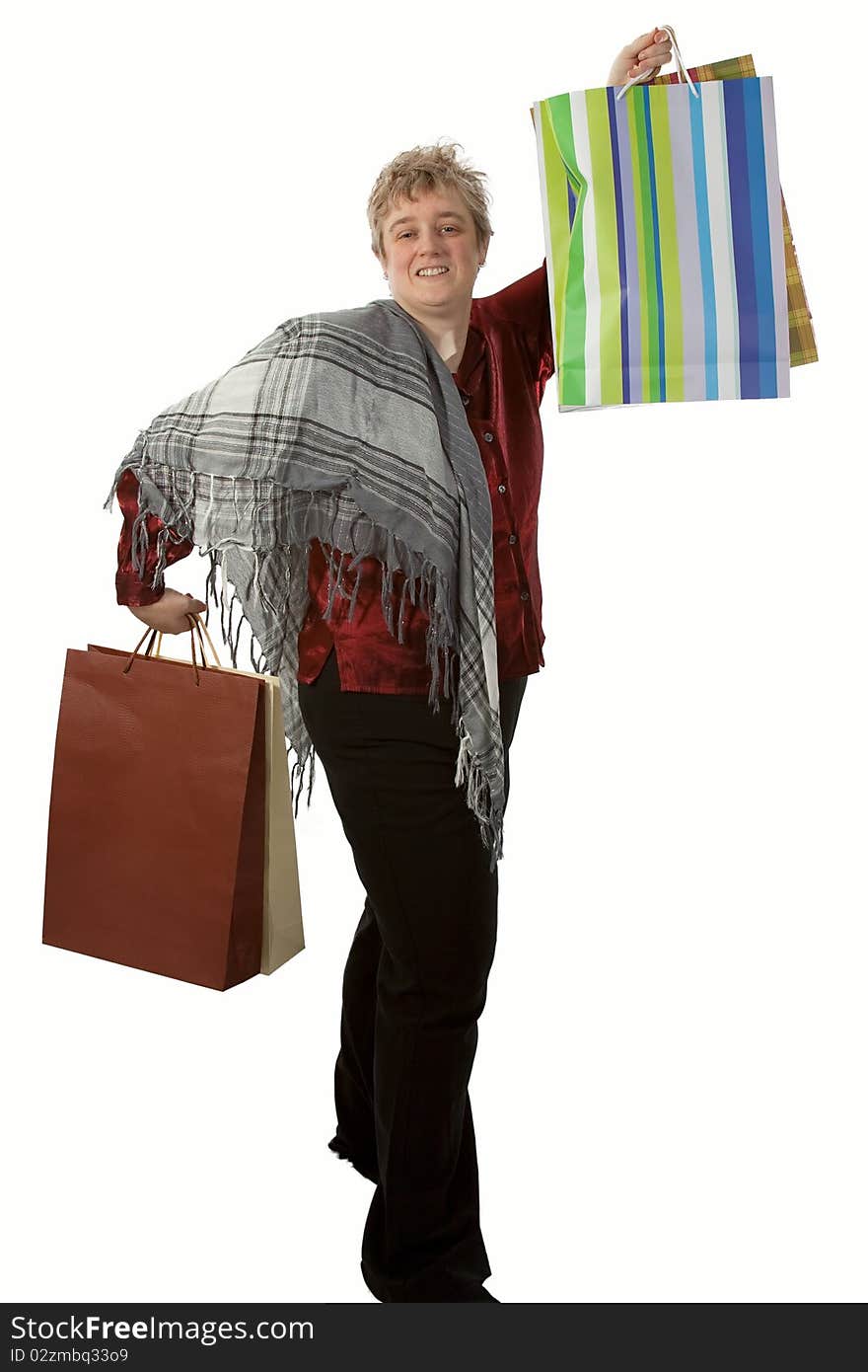 Middle age short hair blond woman holding several shopping bags. Middle age short hair blond woman holding several shopping bags