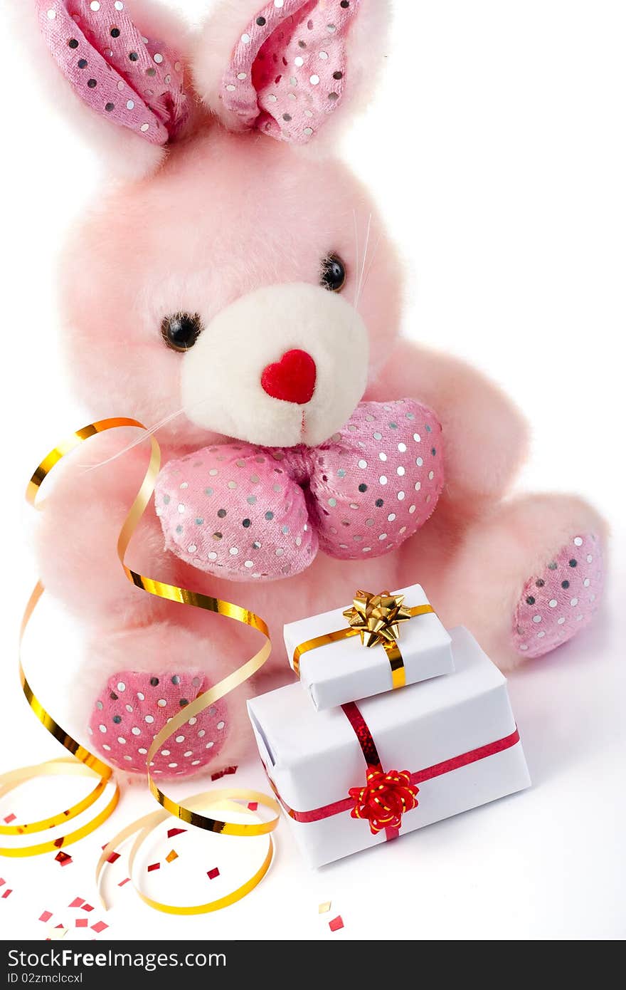 Toy pink rabbit with gifts