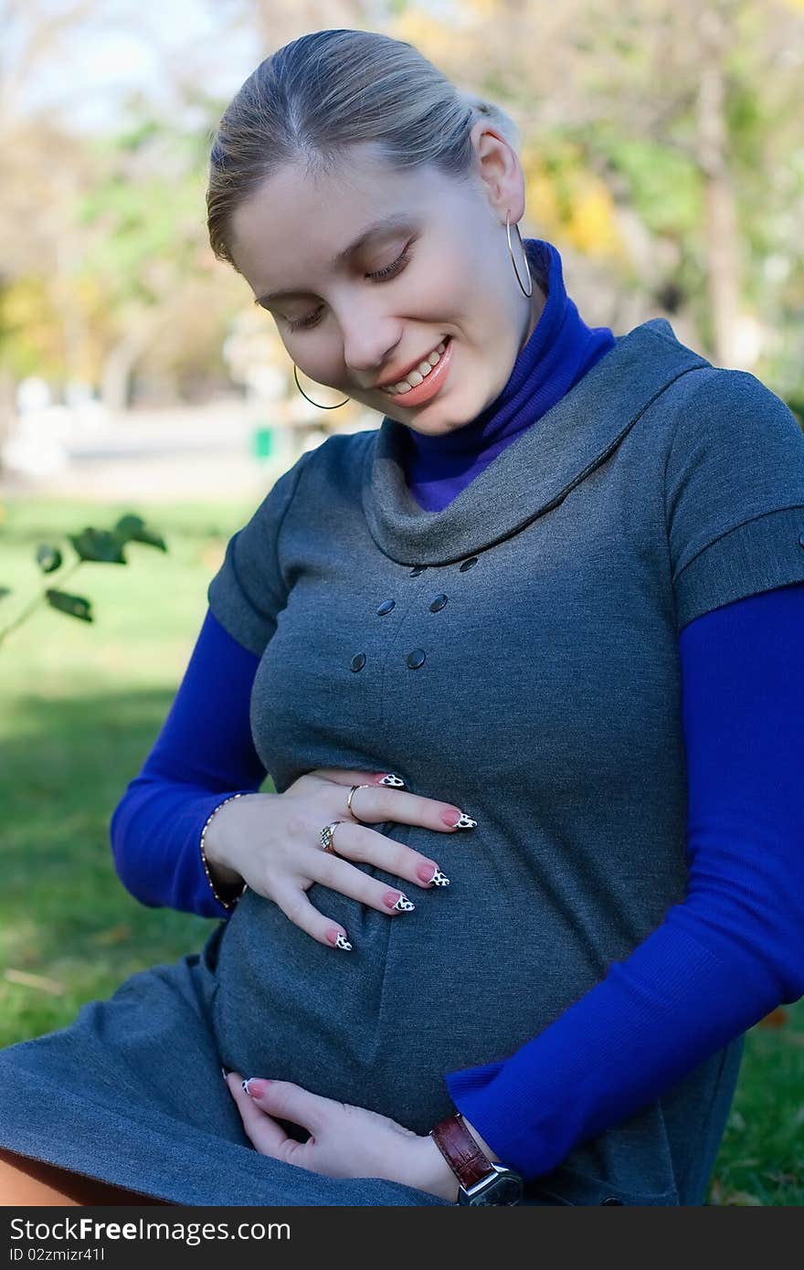 Beautiful pregnant woman in the park. Beautiful pregnant woman in the park