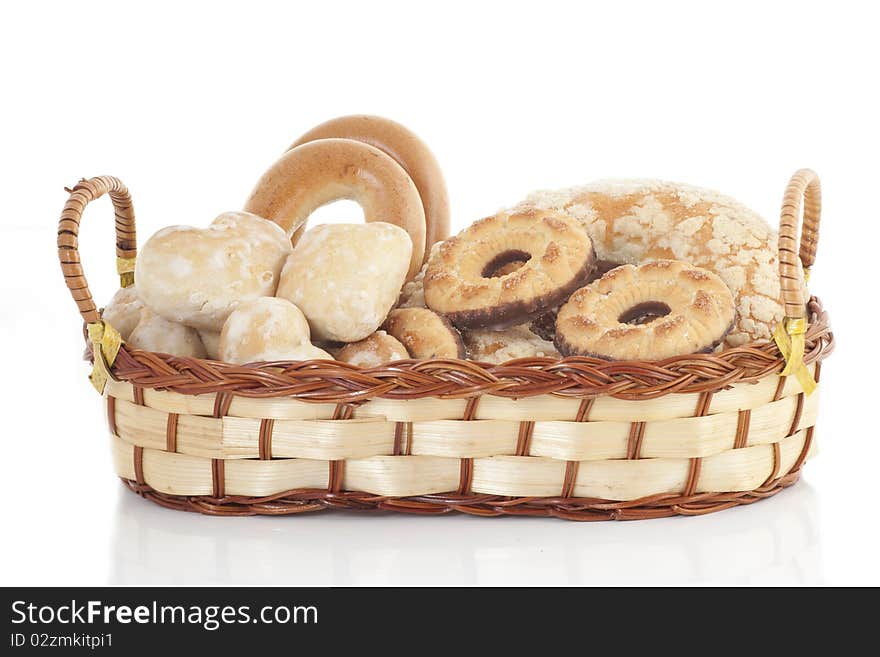 Wattled basket with sweets on a white background