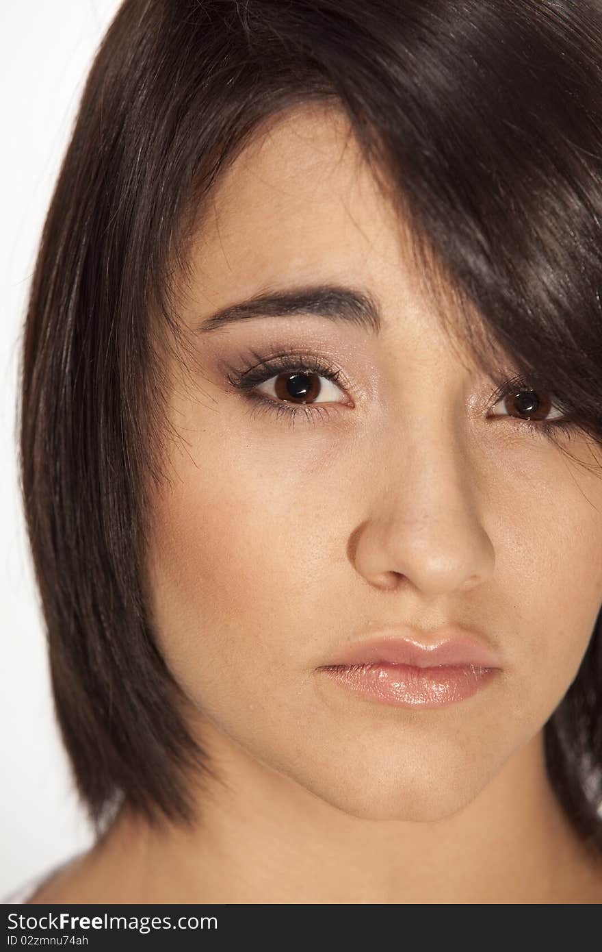 Young brown-eyed brunette looking straight into camera. Young brown-eyed brunette looking straight into camera.