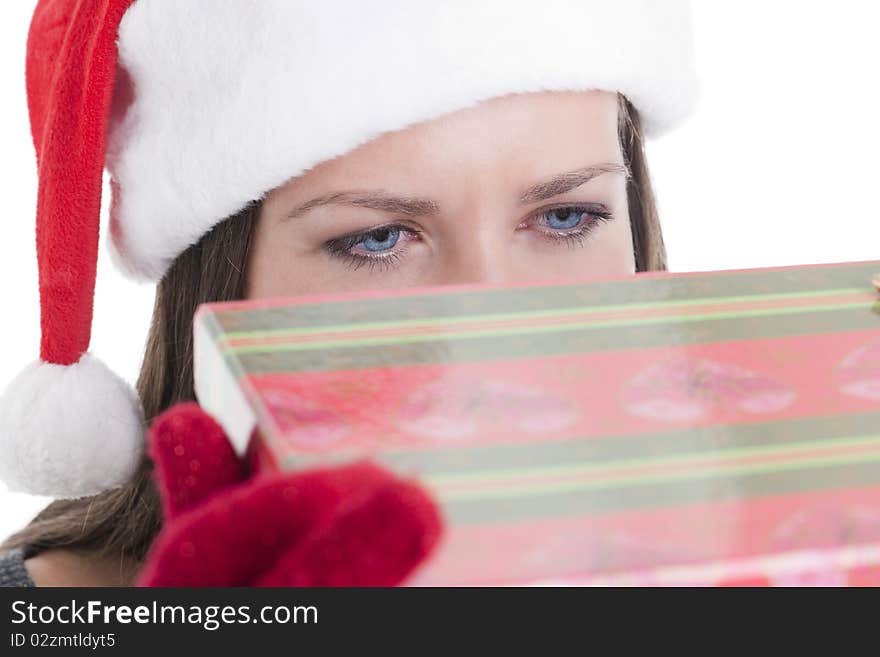 Young woman peeking into a Chritmas present