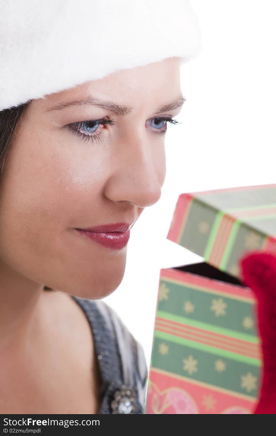 Happy young woman opening a Christmas present. Happy young woman opening a Christmas present