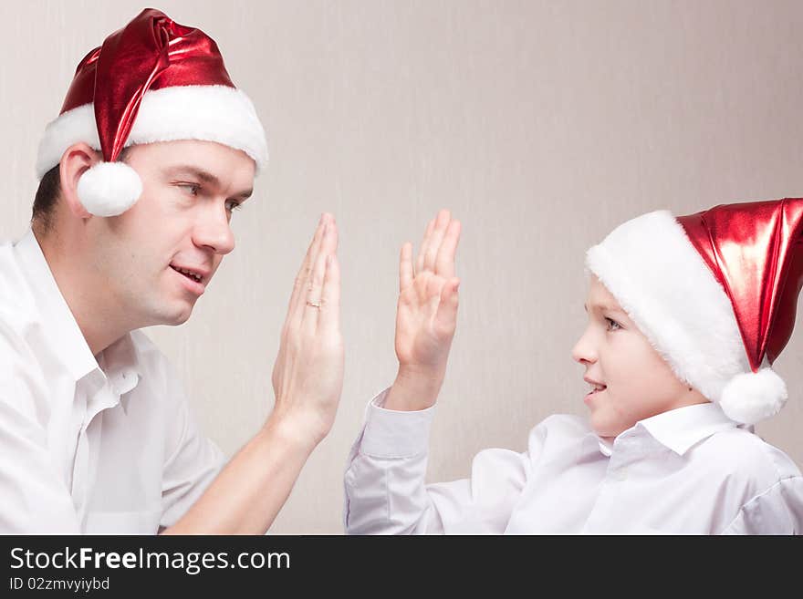 Happy and merry father and son in santa hat. Happy and merry father and son in santa hat