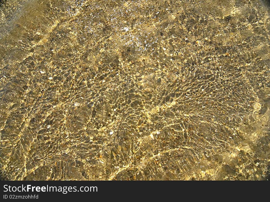 Beautiful clear sea water with seashells on bottom reflecting in the sun. Beautiful clear sea water with seashells on bottom reflecting in the sun