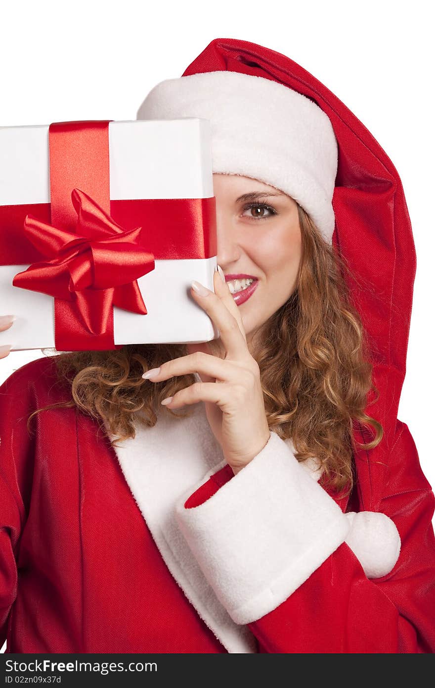 Young smiling Santa emerge from behind a gift box isolated on white