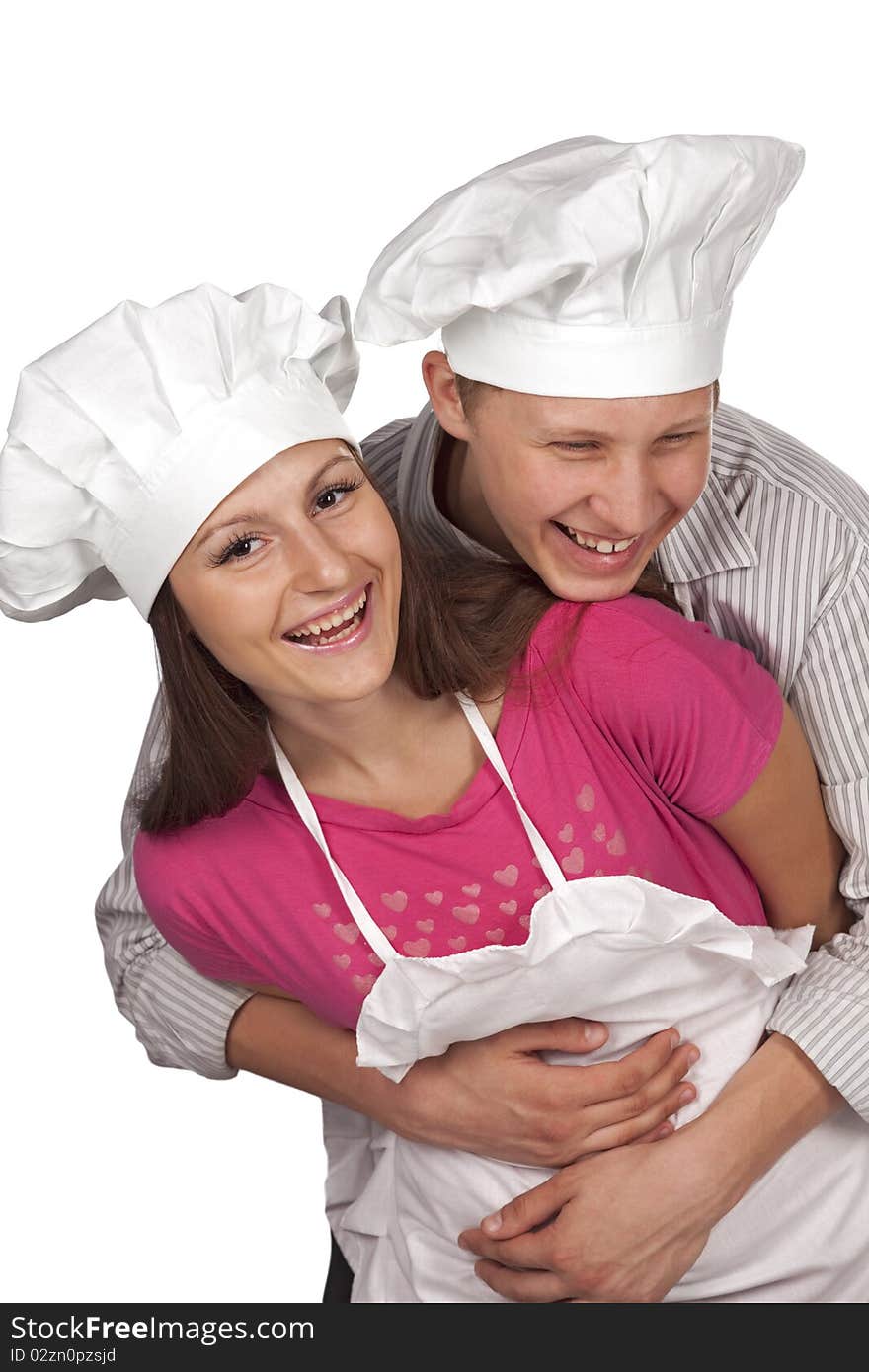 Young loving couple cooks. Over white background