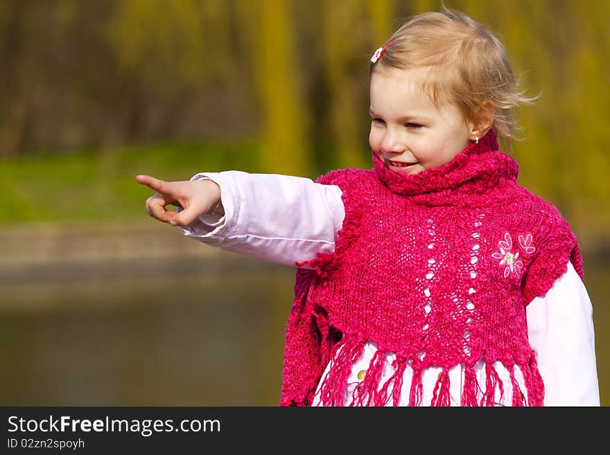 Little girl pointing on something.