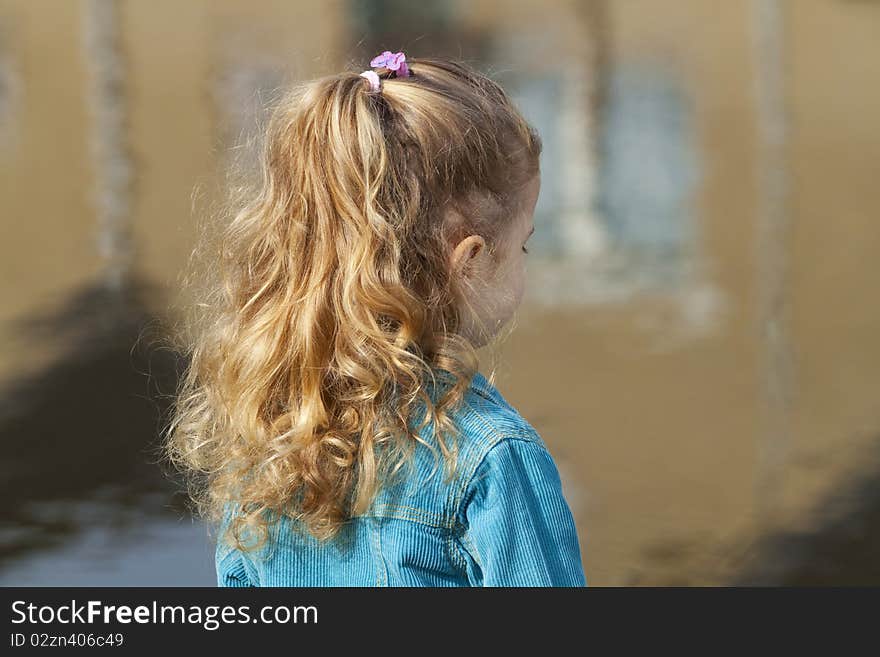 Little girl looking at river.