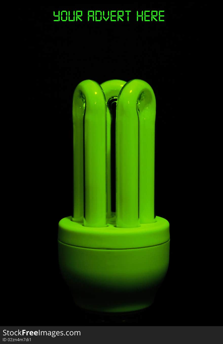 Picture of a flourescent green glowing low energy bulb, eco friendly product on a black background. Picture of a flourescent green glowing low energy bulb, eco friendly product on a black background.