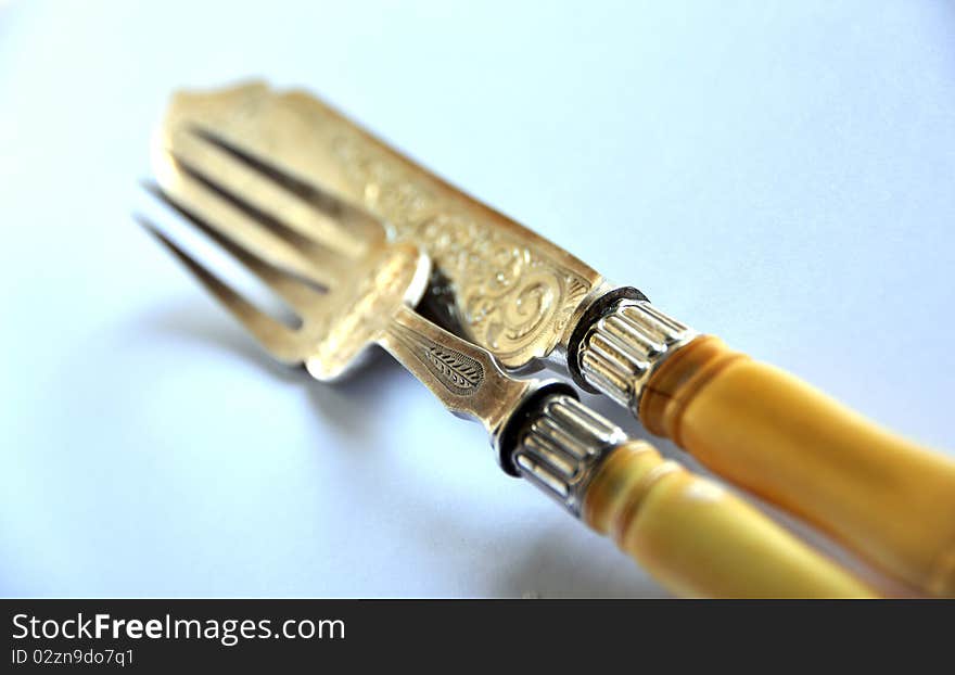 Luxury cutlery, with ivory handle and work over white background. Luxury cutlery, with ivory handle and work over white background