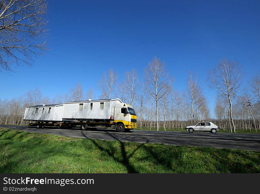 Transporting prefabricated house by the road. Transporting prefabricated house by the road