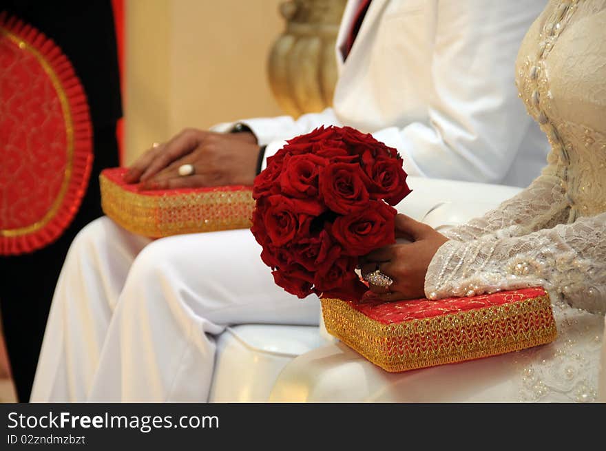 Bouquet of red roses in the hands of newly married couple. Bouquet of red roses in the hands of newly married couple