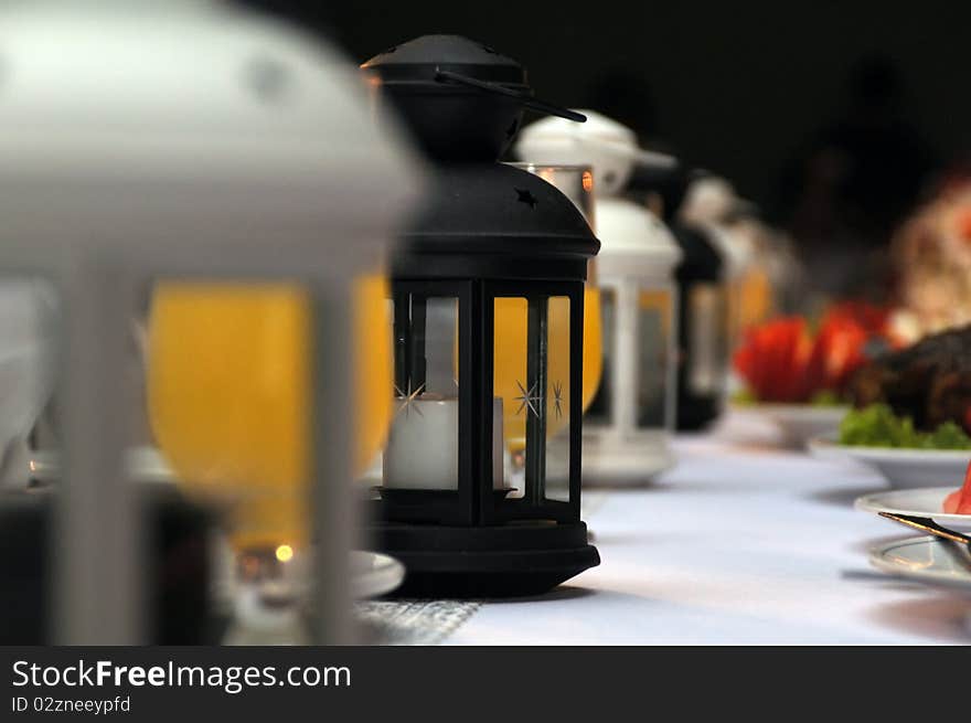 A lantern style candle holder lineup on table