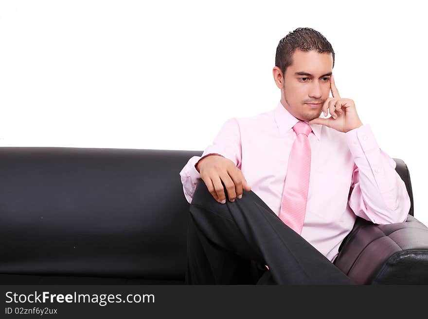 Business man thinking in a sofa, isolated on white