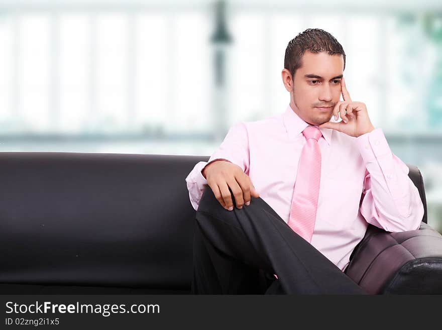 Businessman thinking on a sofa, indoor image