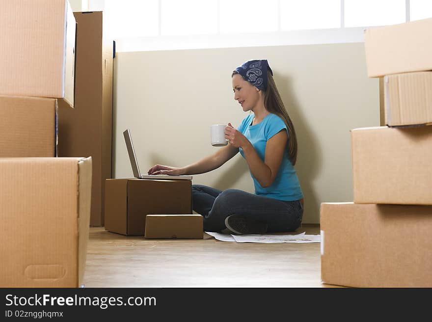 Woman with laptop in new home