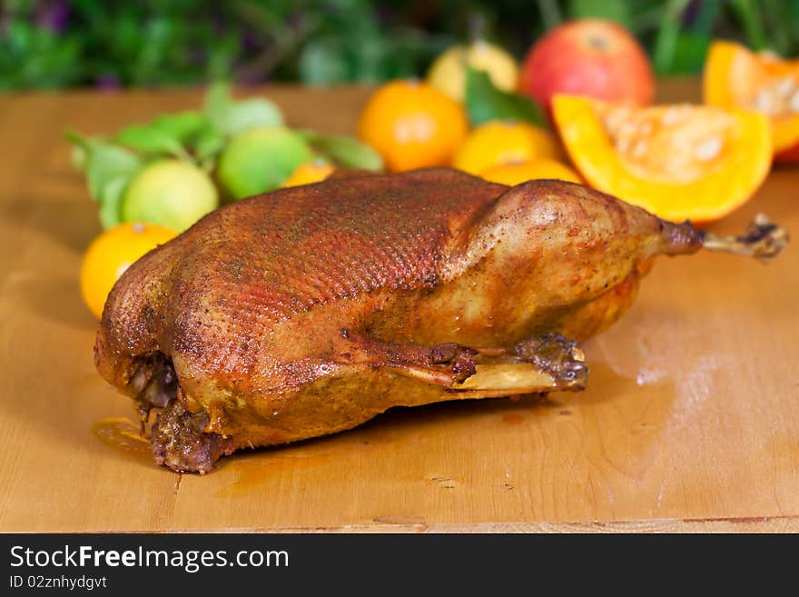 Fresh and Baked Goose with decoration of fruits .