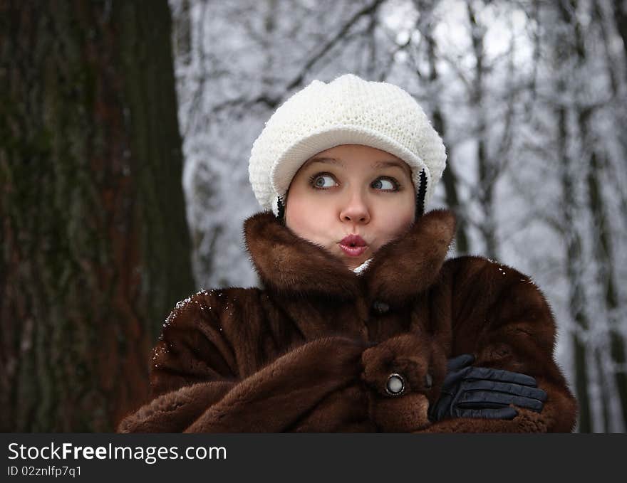 The girl in a fur coat, has frozen, is surprised. The girl in a fur coat, has frozen, is surprised