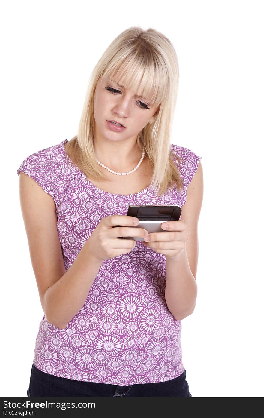 A woman confused at a text she is receiving on her cell phone. A woman confused at a text she is receiving on her cell phone.