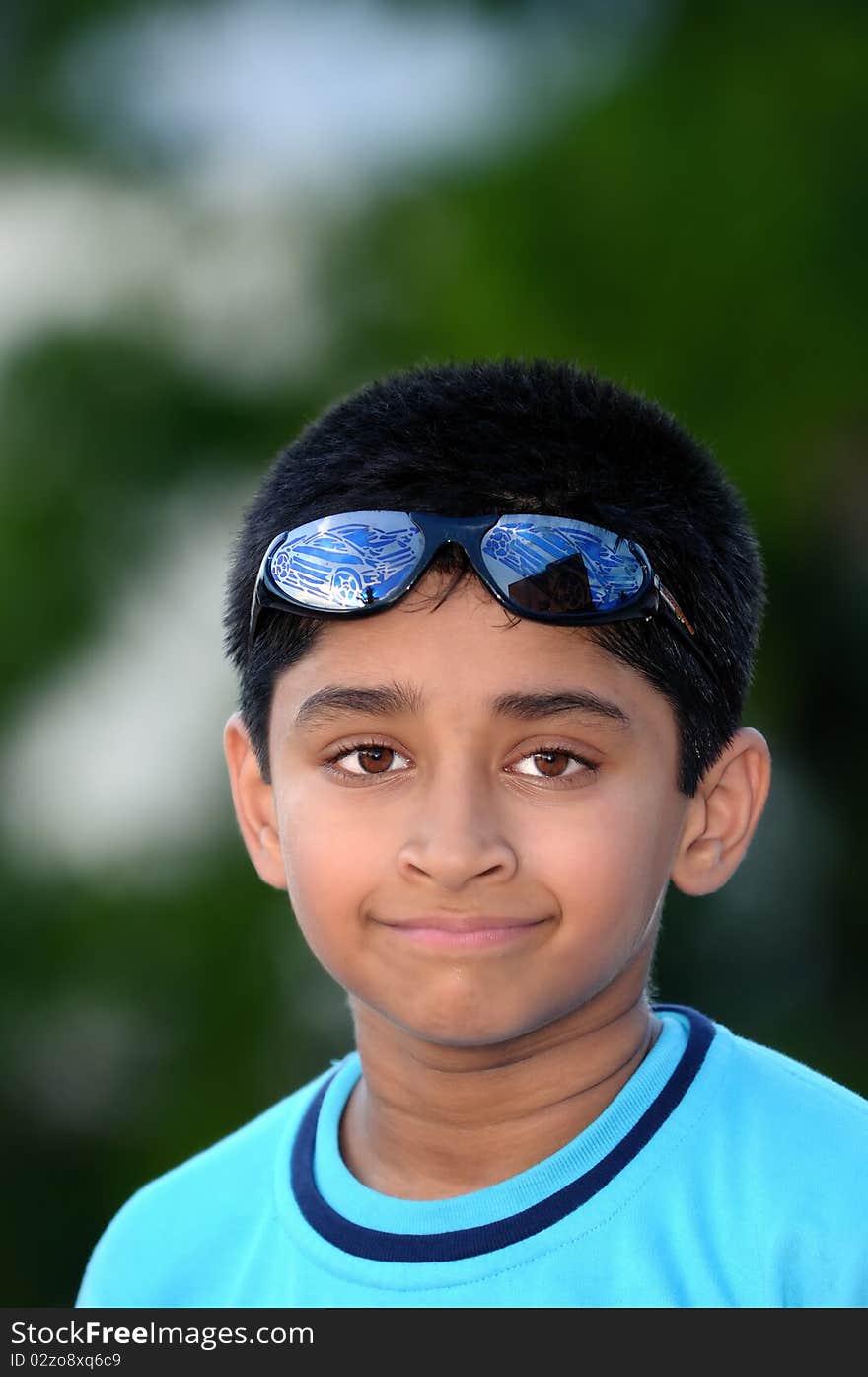 An handsome young Indian kid looking very happy