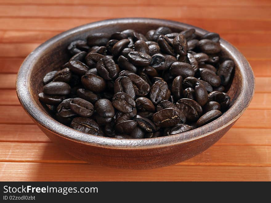 Coffee beans in a wooden bowl