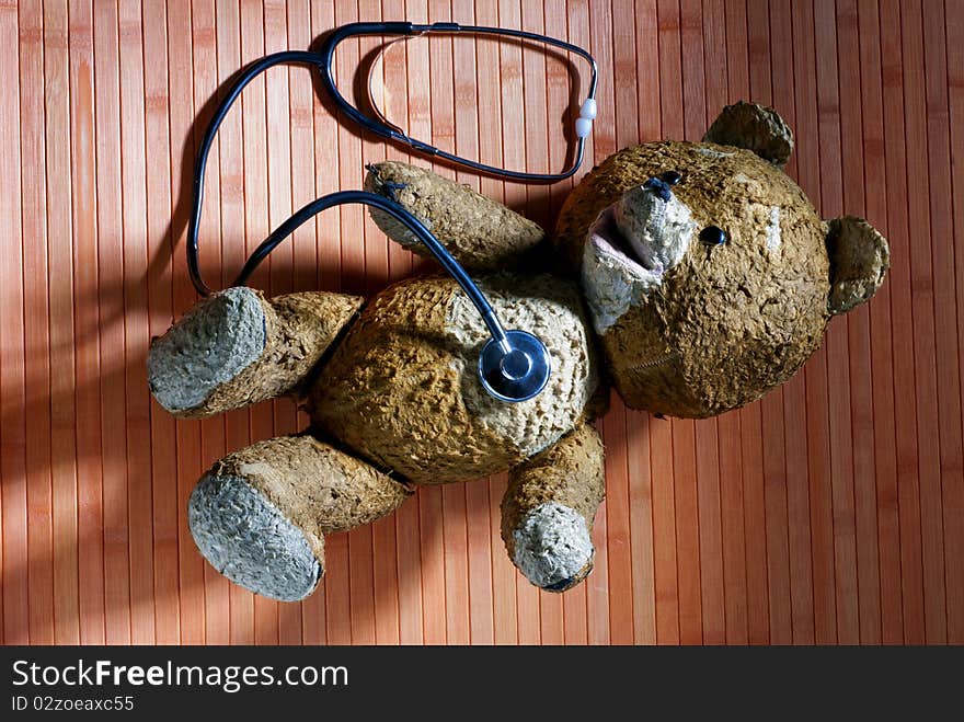 Old teddy bear with a stethoscope