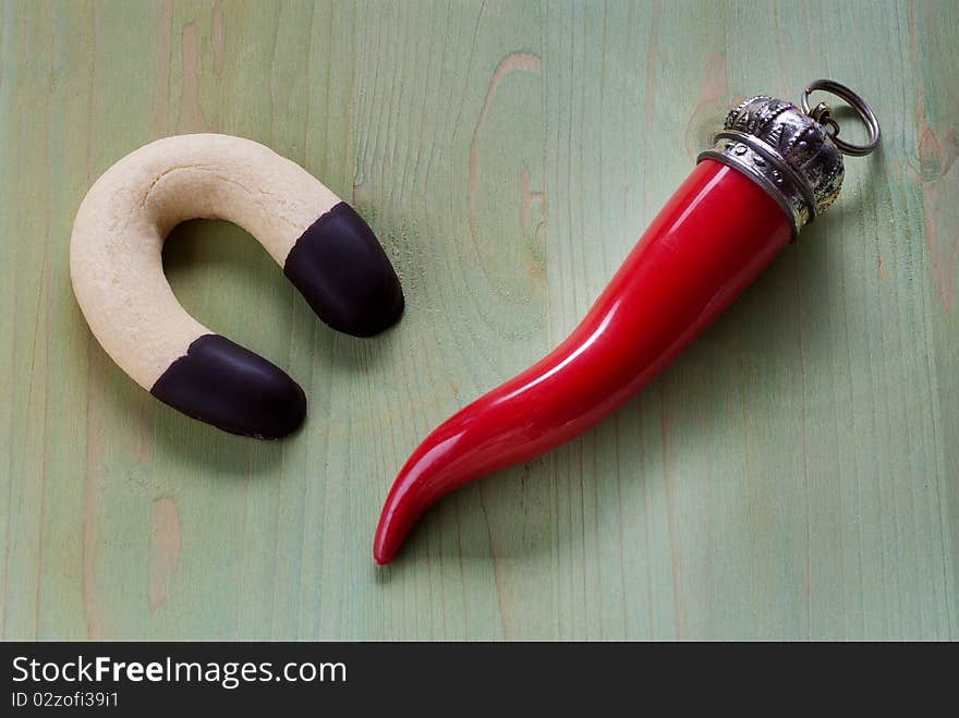 Chocolate biscuit in the shape of a horseshoe and a red horn. Chocolate biscuit in the shape of a horseshoe and a red horn