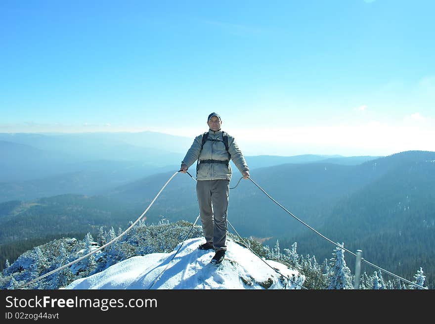 Tourist in mountains on winter day