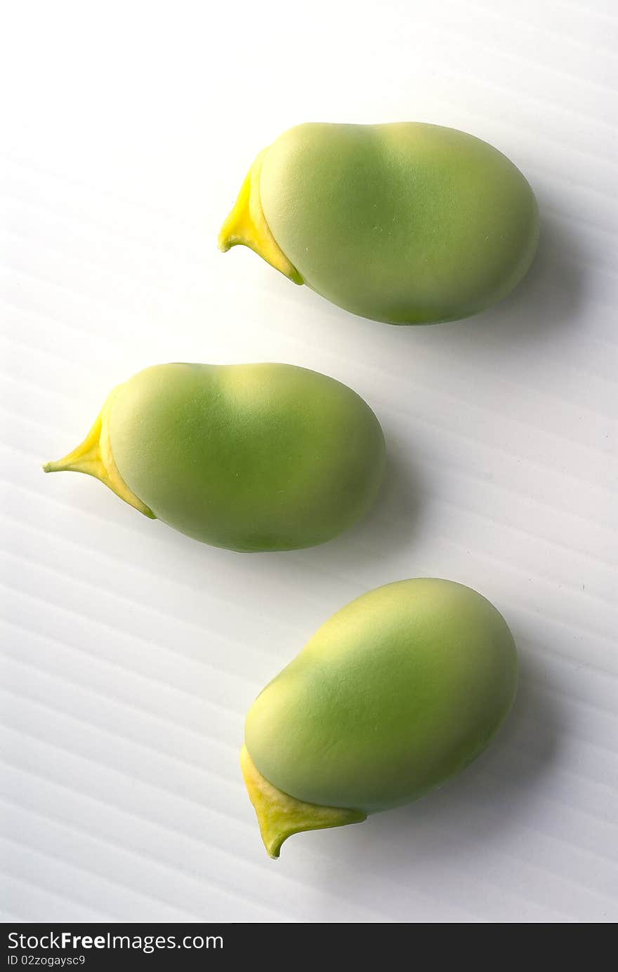 Three fresh beans on white background