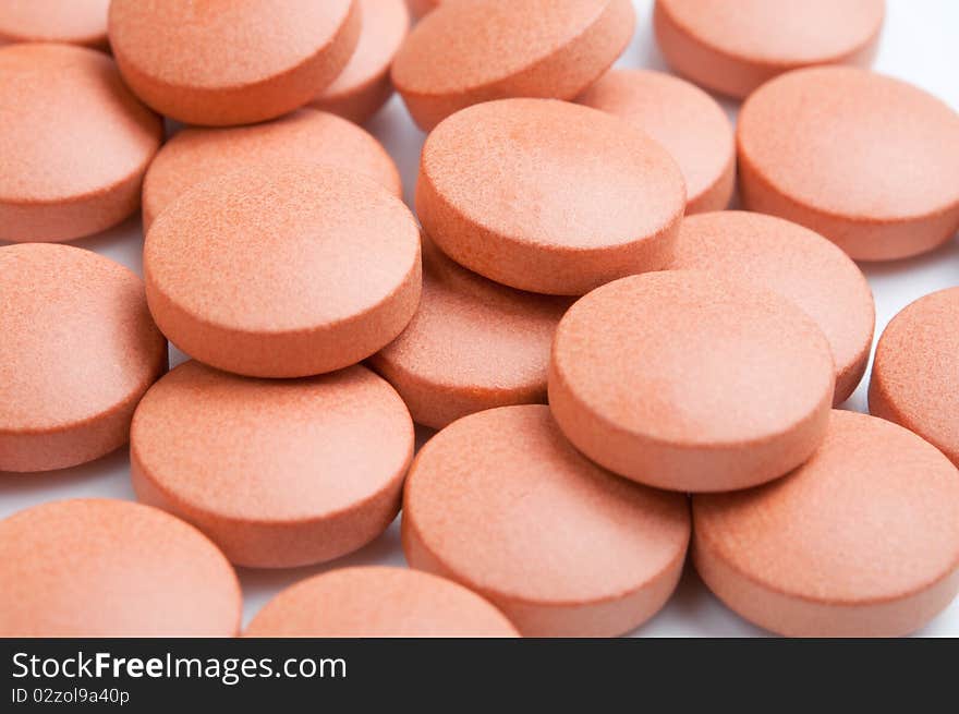 Close-up of many orange pills, selective focus. Close-up of many orange pills, selective focus.