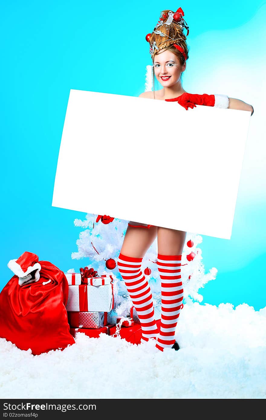 Beautiful young woman in Santa Claus clothes over Christmas background. Beautiful young woman in Santa Claus clothes over Christmas background.