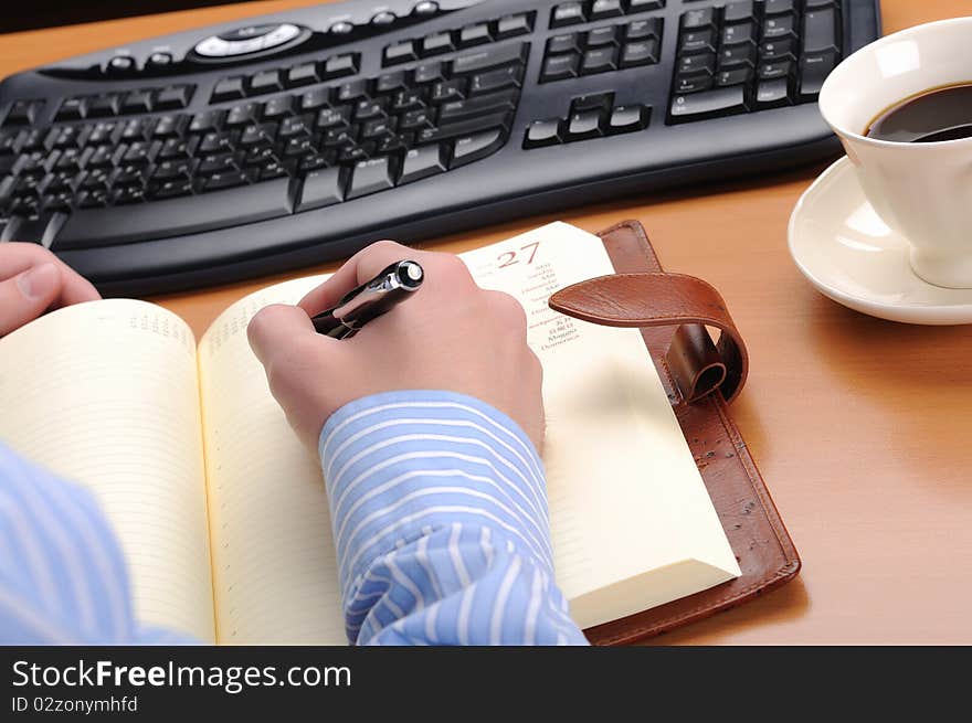 A young business man working in an office at his workplace.