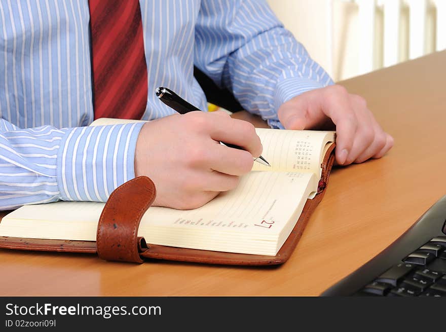 A young business man working in an office at his workplace.