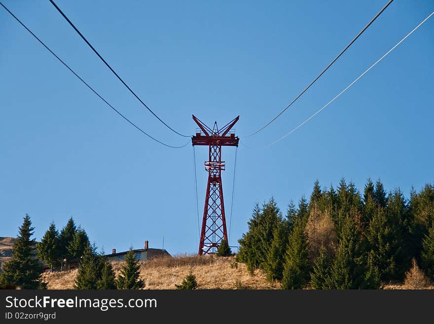 Cable railway in the mountains on blue sky