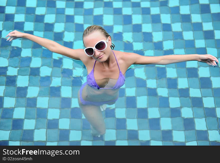 Beautiful young woman relaxing in the pool. Beautiful young woman relaxing in the pool