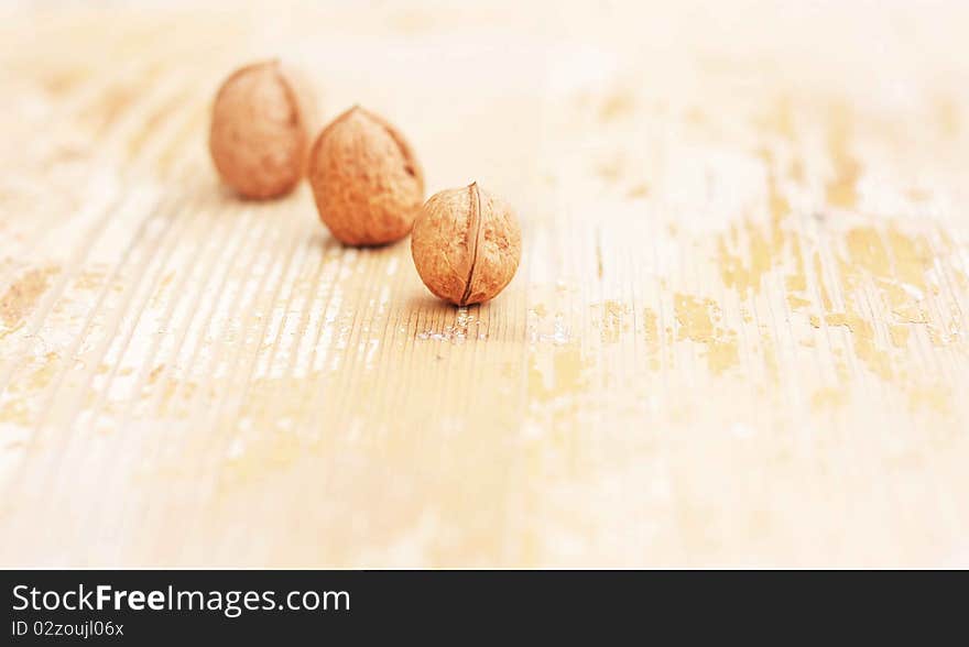 Walnuts three consecutive on natural wood background for use in the manufacture of natural wood doors