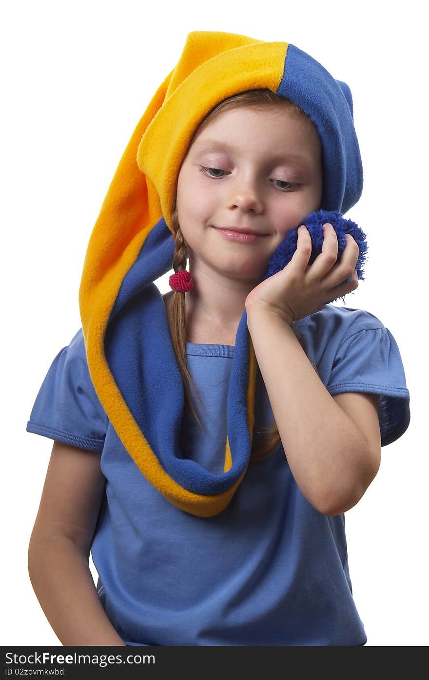 Little girl in the yellow-blue gnome cap isolated over white background. Little girl in the yellow-blue gnome cap isolated over white background