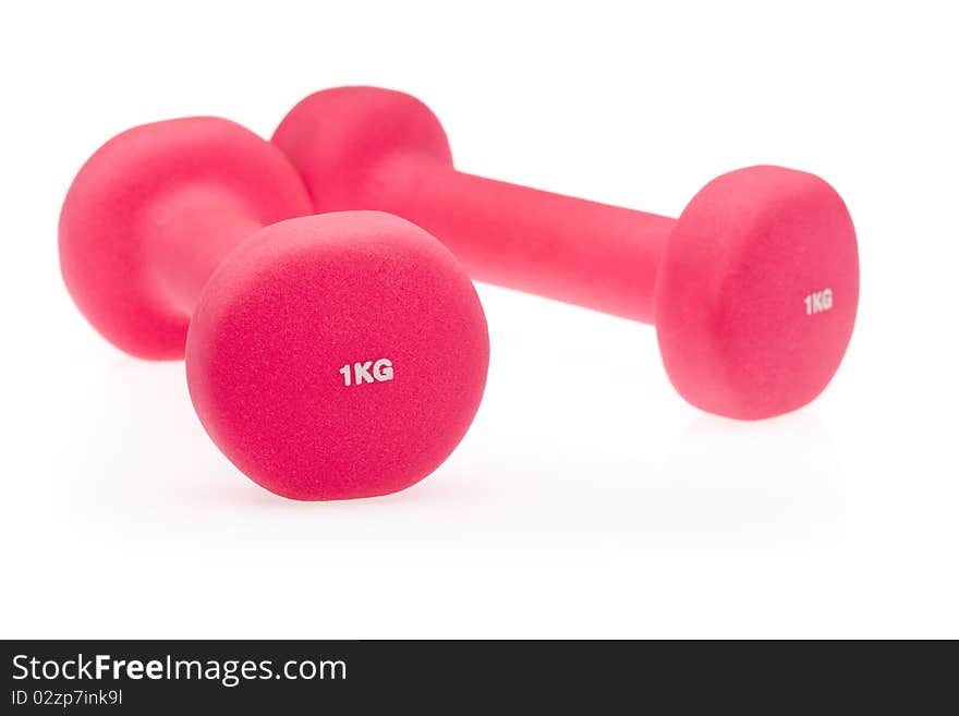 Two pink dumbbells isolated on white background