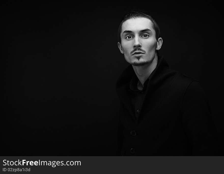 Attractive young man wearing elegant black suit