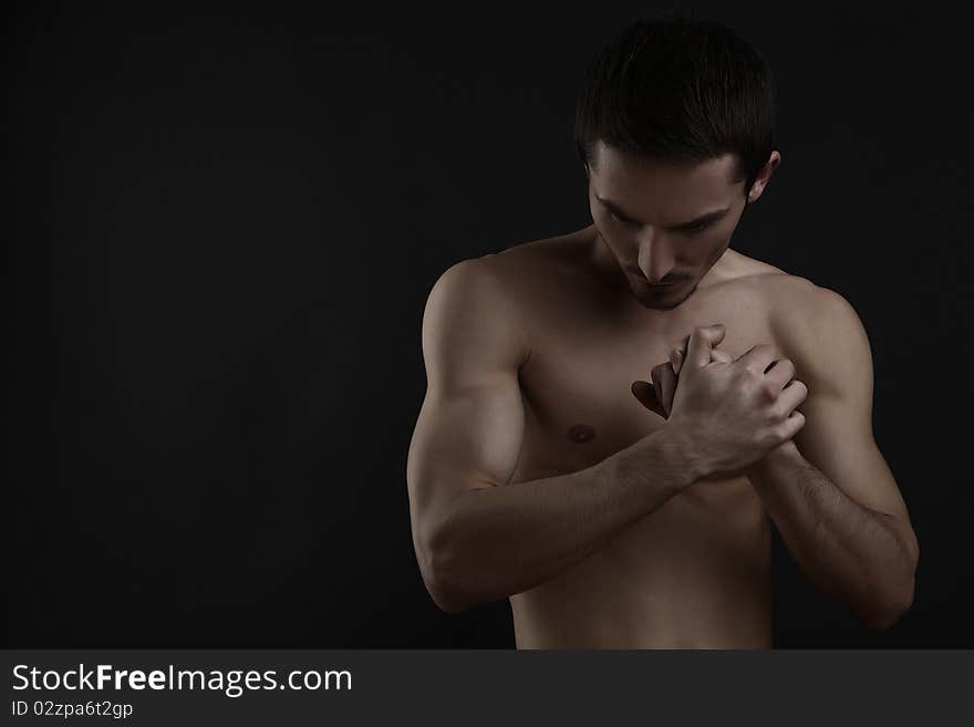 Beautiful athletic caucasian man on dark background