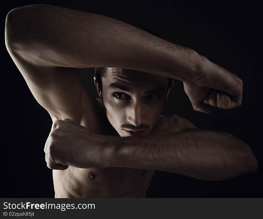 Beautiful athletic caucasian man on dark background