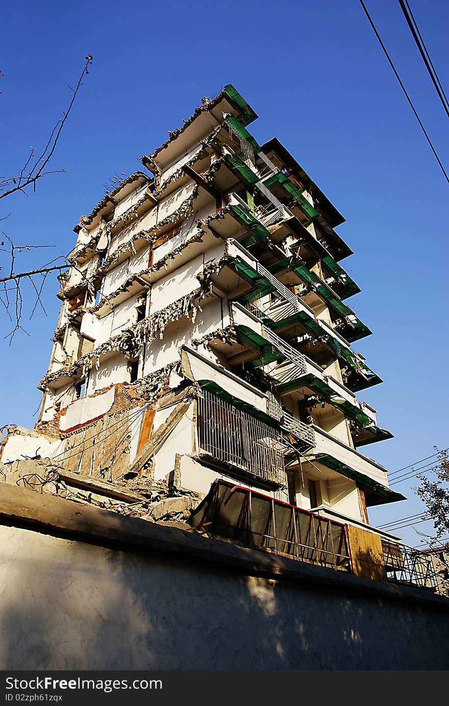 Partially demolished high rise building with pile of rubble at bottom. Partially demolished high rise building with pile of rubble at bottom.