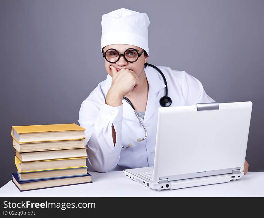 Young Doctor With Books And Computer.