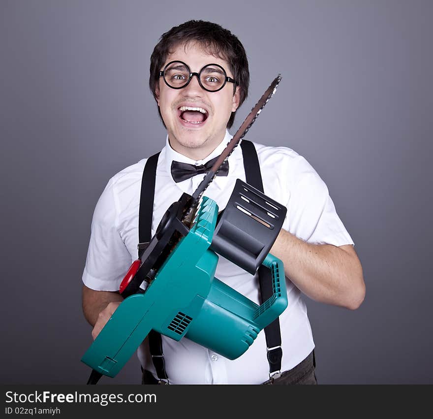 Men in suspender keeping portable saw