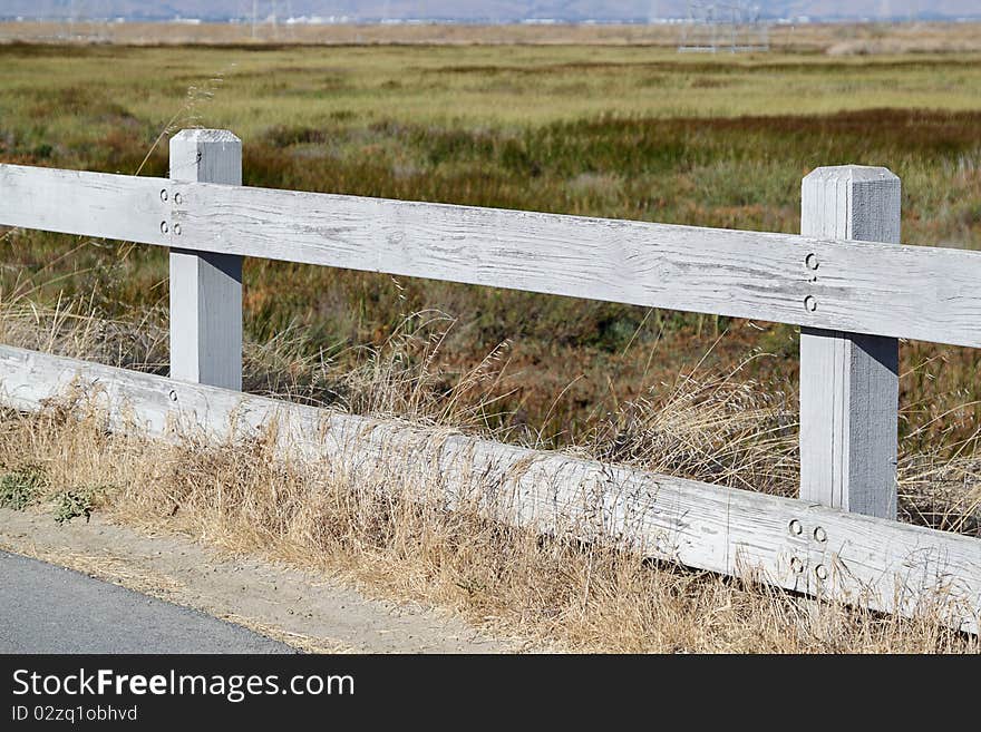 Old wooden fence with field of glass as background