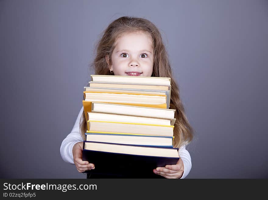 Little schoolgirl with books.