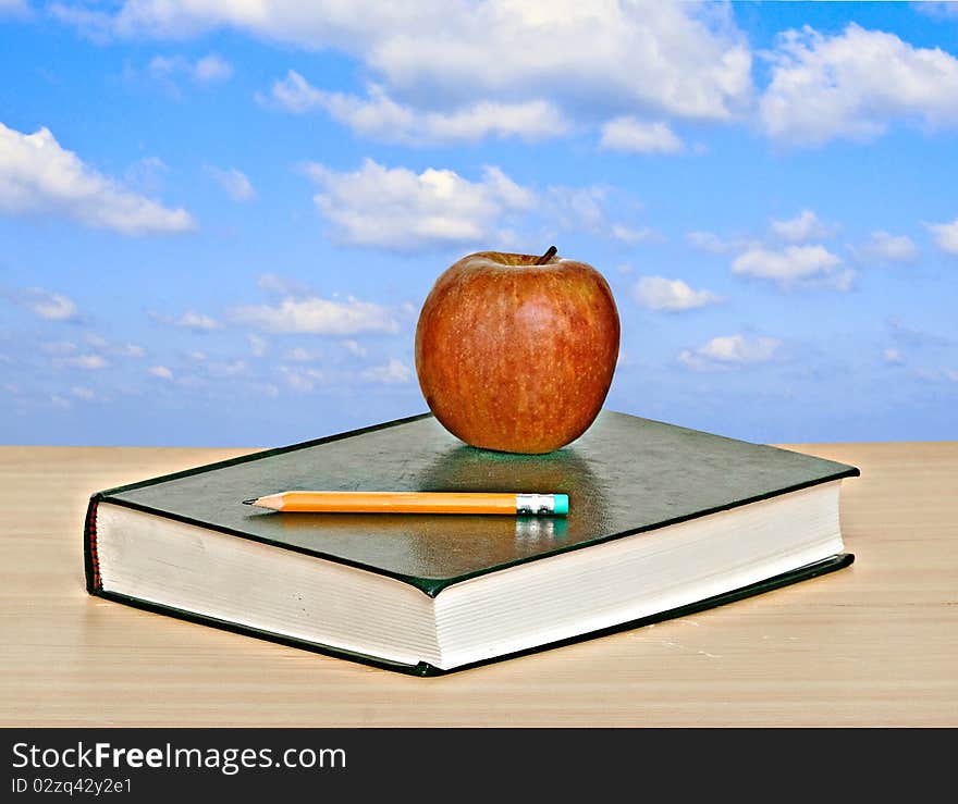 Apple And Book On Desk