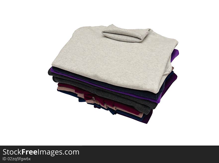 Small heap of modern sweaters isolated on a white background. Small heap of modern sweaters isolated on a white background.