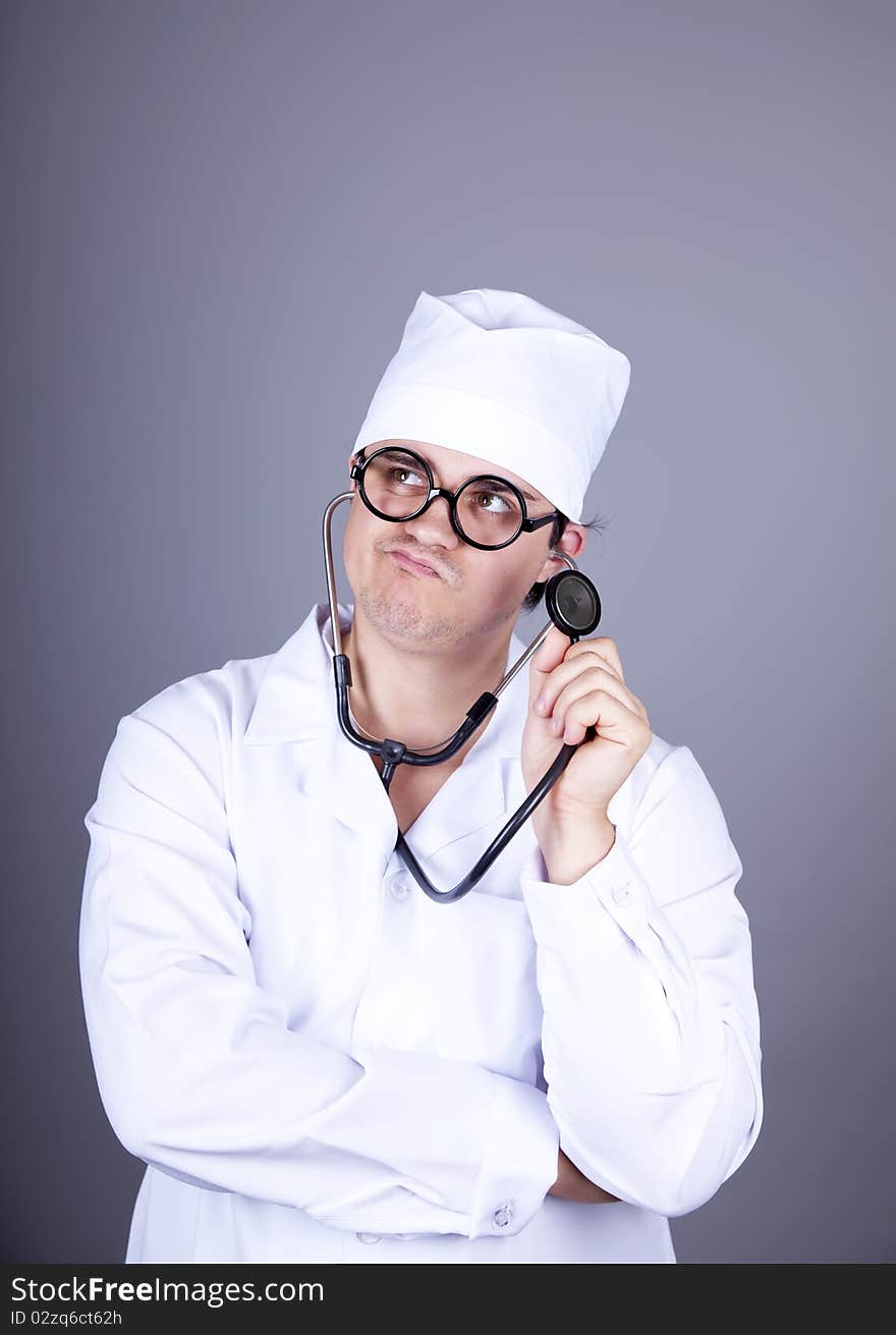 Crazy doctor with a stethoscope. Studio shot.